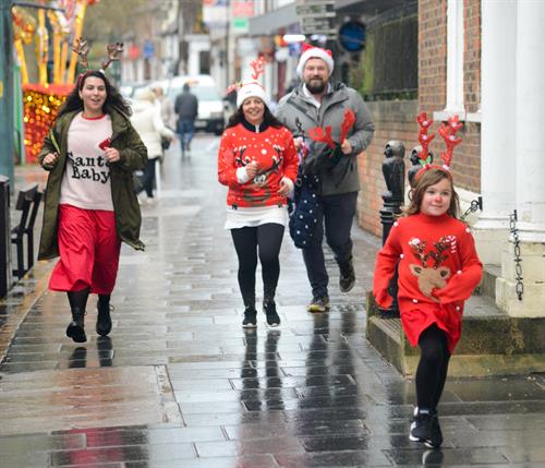 Olive sprints towards the rudolph run finish line ahead of her family
