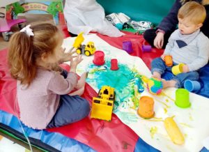 Two children engage in messy play activities